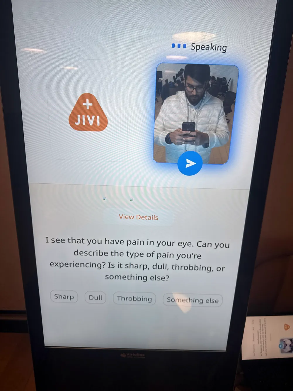 The Jivi app running on a kiosk screen, mid voice consultation, asking about the type of eye pain.
