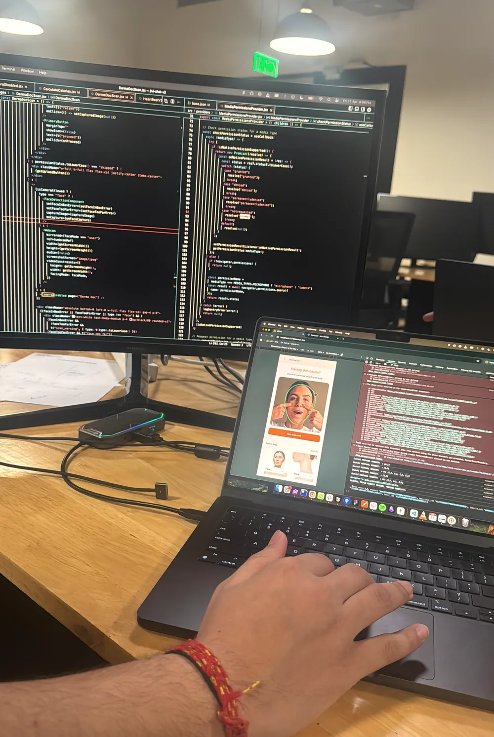 Anurag's desk: code on an external monitor and Neura running on a laptop.