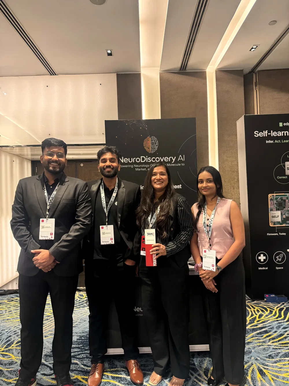 Anurag with three NeuroDiscovery AI colleagues at the company's event booth.