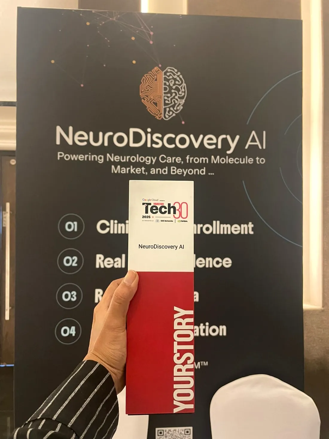 Tech30 trophy in front of the company banner