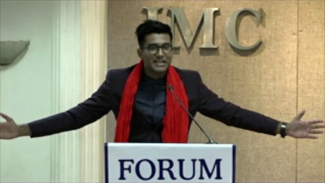 Anurag speaking at the IMC Forum podium