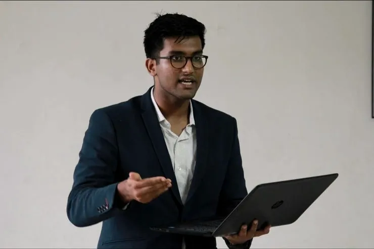 Anurag presenting with a laptop